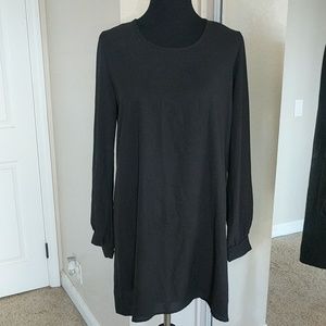 Long sleeve black dress with upper back cut out.